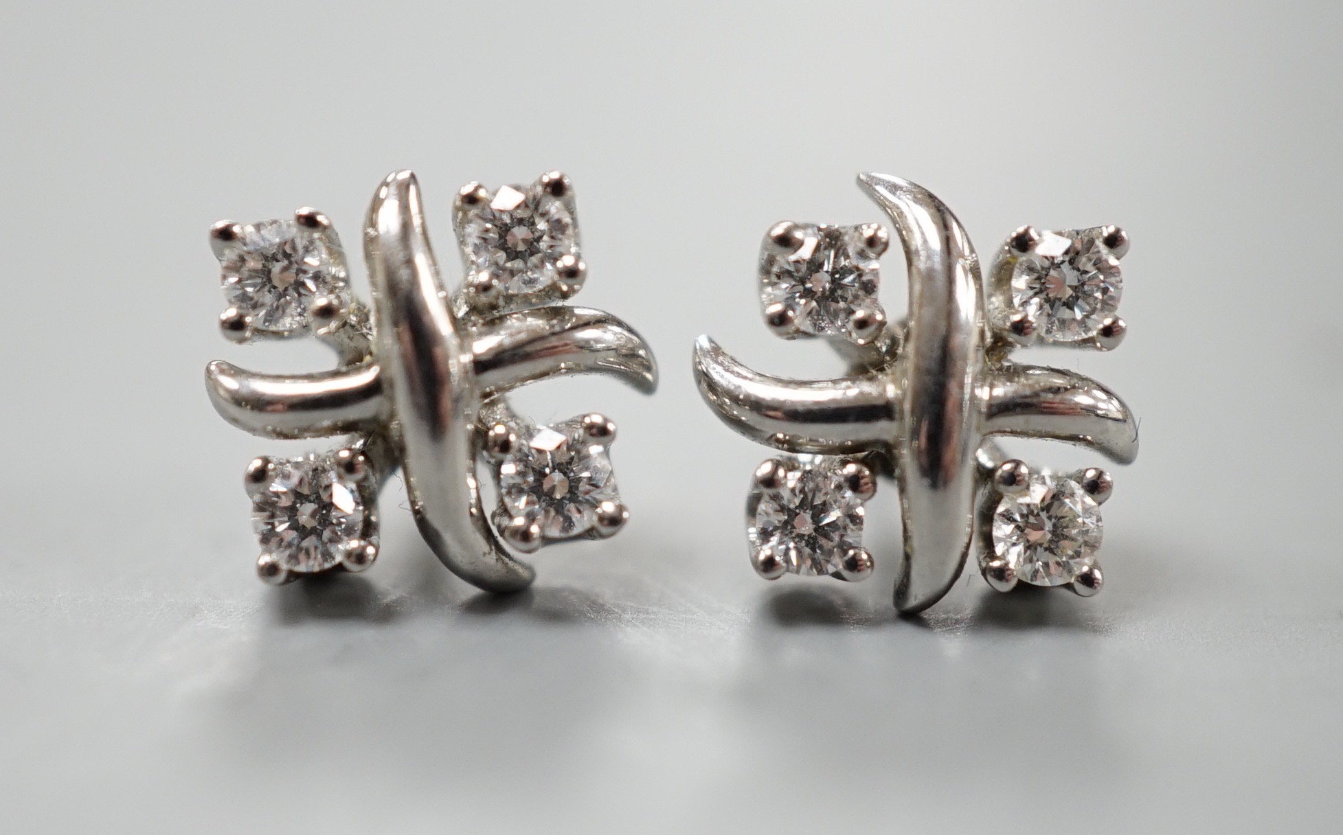 A modern pair of Tiffany & Co platinum and four stone diamond set square cluster ear studs, 7mm, gross weight 3.9 grams, (associated butterflies).